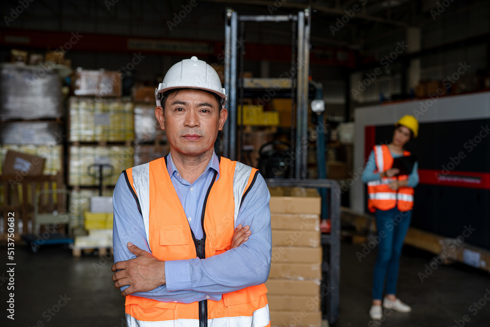 Portrait of male supervisor standing in warehouse with his arm crossed looking at camera. Portrait of male supervisor standing in warehouse with his arm crossed looking at camera.