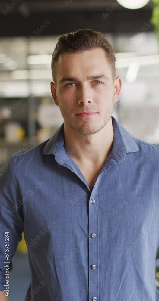Vertical video of portrait of happy caucasian businessman at office Vertical video of portrait of happy caucasian businessman at office