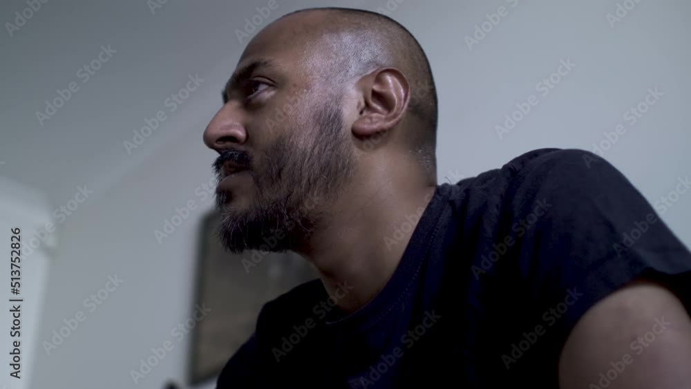 Bald UK Asian Male Watching TV Off Screen Expressively With Eyes. Low Angle, Locked Off Bald UK Asian Male Watching TV Off Screen Expressively With Eyes. Low Angle, Locked Off