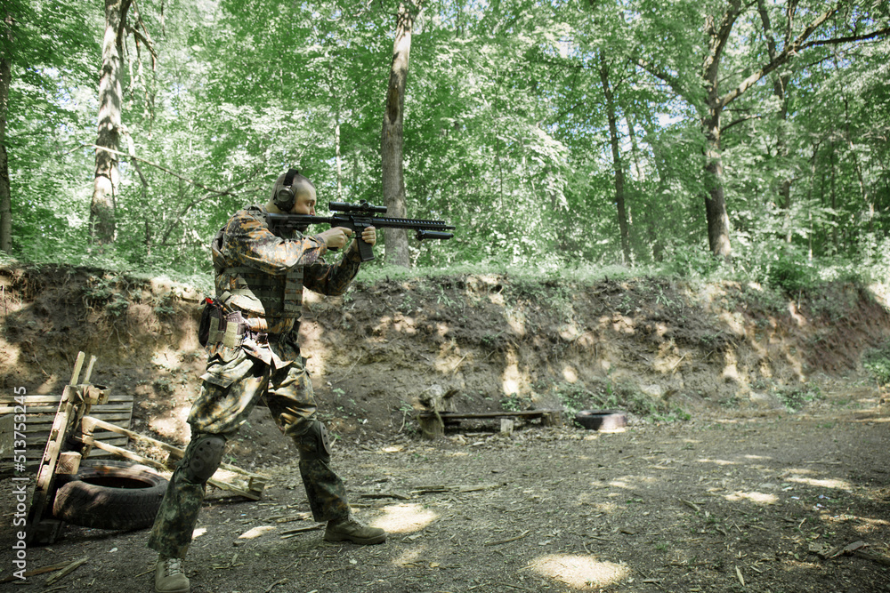 A soldier fires a machine gun Ar-15