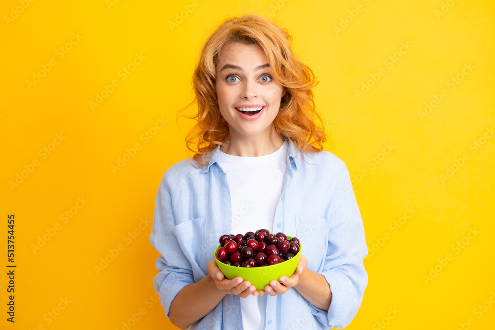 Young stylish woman isolated holding red colorful cherries. Berries harvest season. Summer diet with organic harvesting cherry. Young stylish woman isolated holding red colorful cherries. Berries harvest season. Summer diet with organic harvesting cherry.