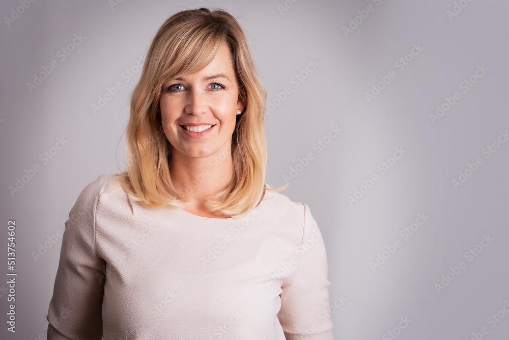 Beautiful blond haired woman wearing casual clothes while standing at isolated background Beautiful blond haired woman wearing casual clothes while standing at isolated background