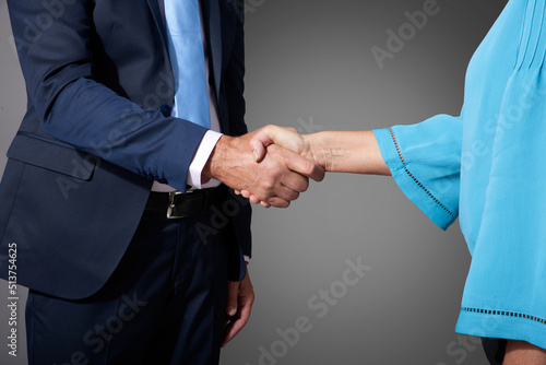 Studio shot of business people shaking hands photo