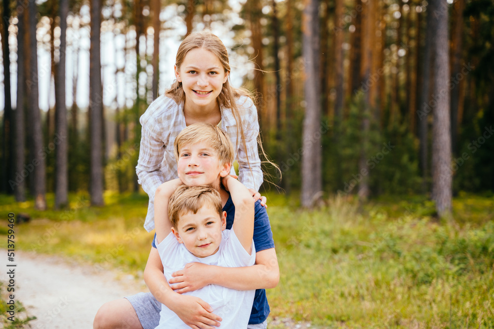Teaching child to love nature, summer camping concept. Teenage friends having fun at summer forest in nature. Teaching child to love nature, summer camping concept. Teenage friends having fun at summer forest in nature.