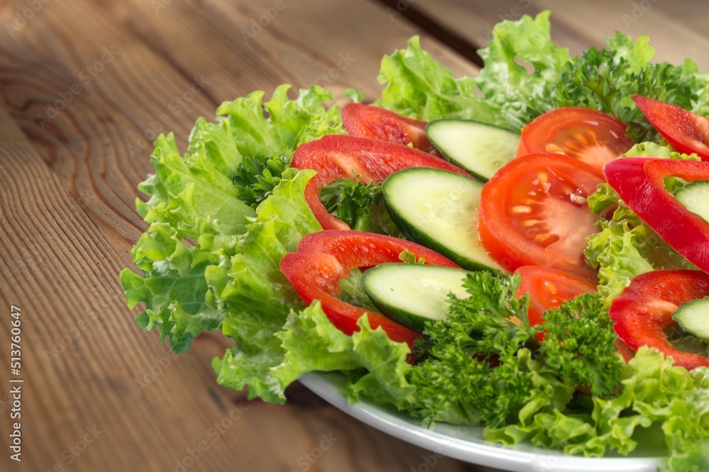 Fresh spring vegetable salad with tomatoes and peppers in the bowl. Fresh spring vegetable salad with tomatoes and peppers in the bowl.