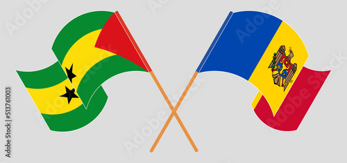 Crossed and waving flags of Sao Tome and Principe and Moldova