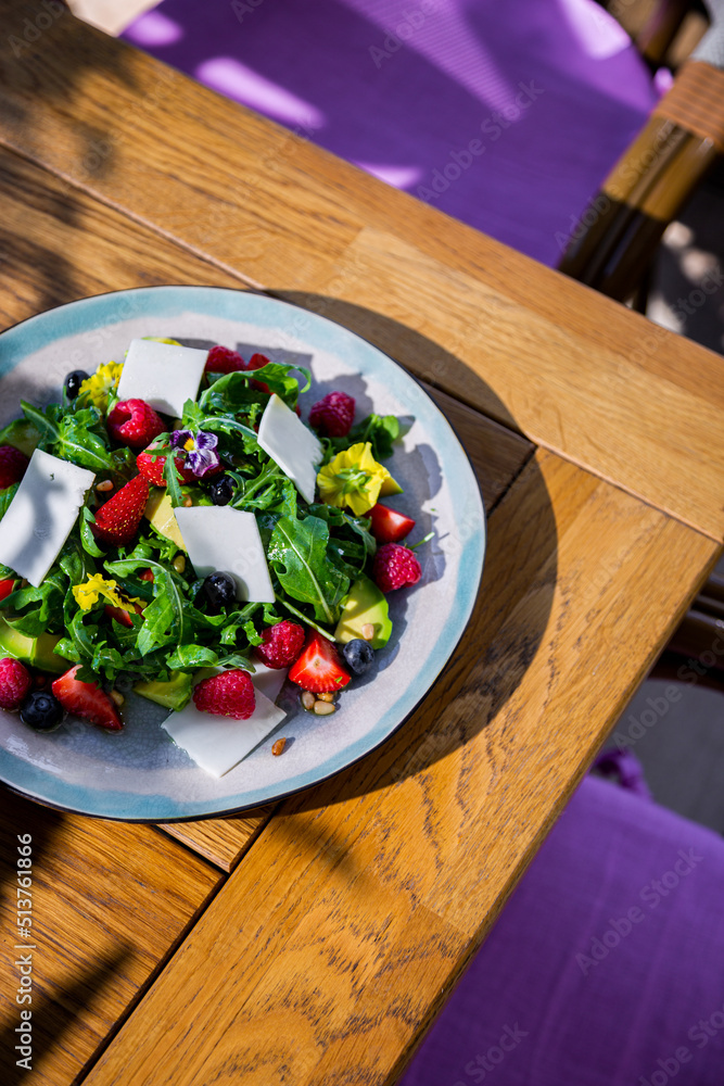 Salad with arugula, raspberries, strawberries, avocado Salad with arugula, raspberries, strawberries, avocado