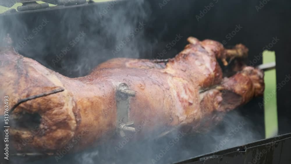Crop cook cutting meat on spit Crop cook cutting meat on spit
