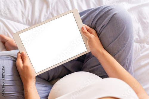 Pregnancy mockup display. Pregnant woman holding smart tablet. Mobile pregnancy online maternity application mock up. Concept maternity, pregnancy, childbirth. © Maksym