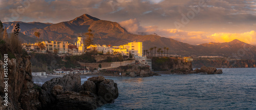 View of Parroquia El Salvador and coastline at sunset in Nerja, Nerja, Malaga Province, Andalucia