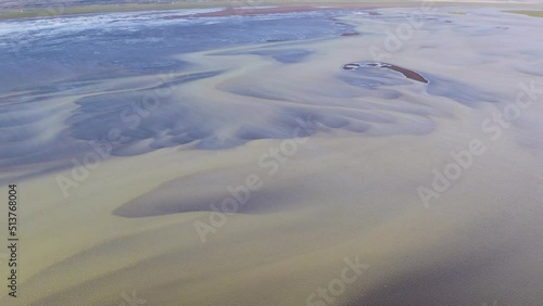 Aerial flyover beautiful Olfusa River with beautiful pattern underwater during sunlight - Iceland,Europe photo