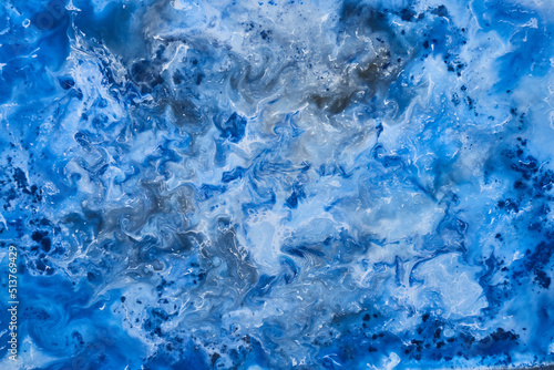 Blue ink abstract background, winter paint pattern under water, acrylic pigment stains, splashes and streaks