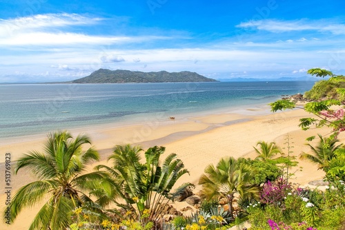 Boat on the beach seen through lush vegetation at Nosy Komba island, in the North West of Madagascar, Indian Ocean