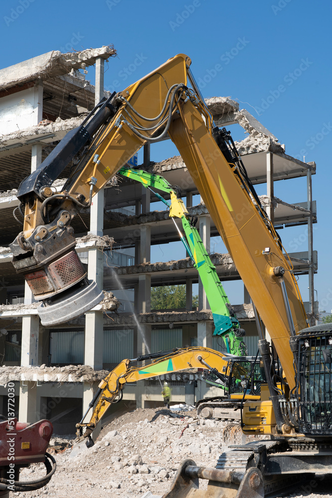 heavy duty Excavators demolishing an old commercial business house building