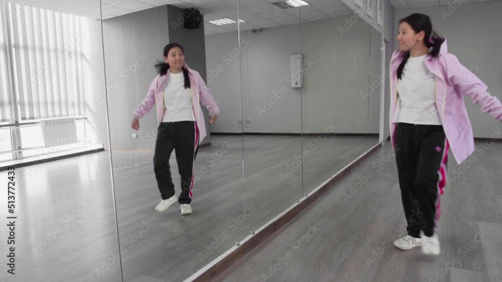 Young professionaly attractive asian woman dancing hip hop in studio Young professionaly attractive asian woman dancing hip hop in studio