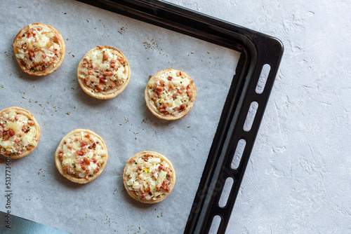 Mini Flammekueche, or tarte flambee, french specialty, on the oven-tray photo