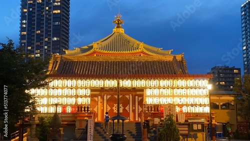 Beautiful scenery of night temple at Tokyo downtown, Ueno “Bentendo” temple on the island of a pond, vivid beautiful sky contrast and the golden paper lantern lights. Year 2022 June 25th