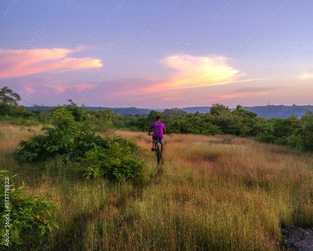 Cycle riding on grassland Cycle riding on grassland