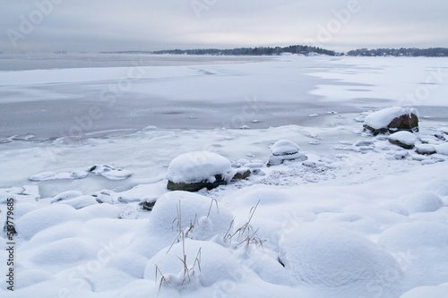 Ice covered rocks on the shore at Lauttasaari  Helsinki  Finland.