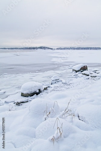 Ice covered rocks on the shore at Lauttasaari, Helsinki, Finland. © Raimo