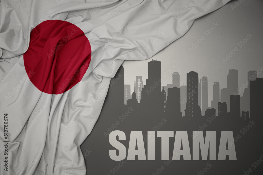 abstract silhouette of the city with text Saitama near waving national flag of japan on a gray background.