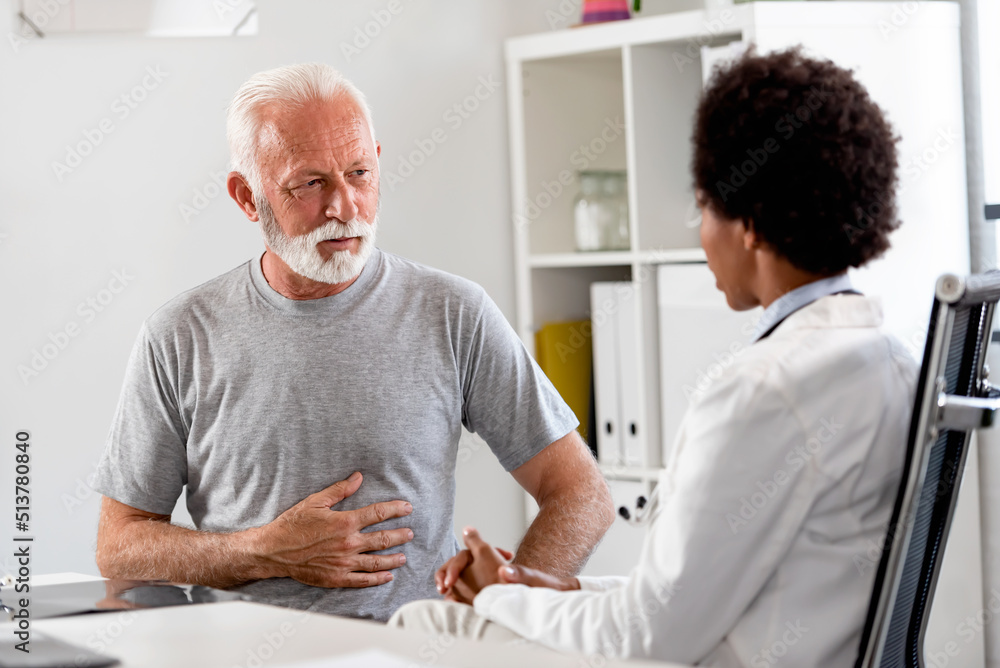 Fototapeta premium Female doctor examining an elderly patient at her office