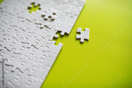 Clean puzzle elements on the background. Empty puzzle piece on the table. Teamwork concept. photo