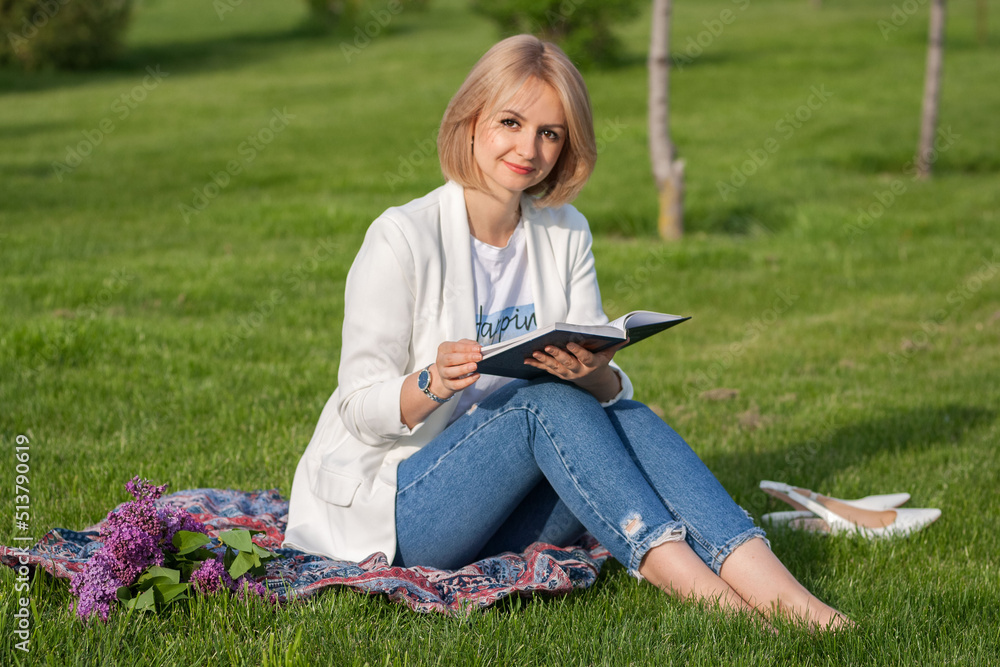 beautiful girl reading a book on the lawn beautiful girl reading a book on the lawn