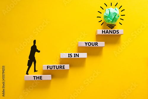 The future is in your hands symbol. Concept words The future is in your hands on wooden blocks on a beautiful yellow table yellow background. Businessman icon. Business future in your hands concept.