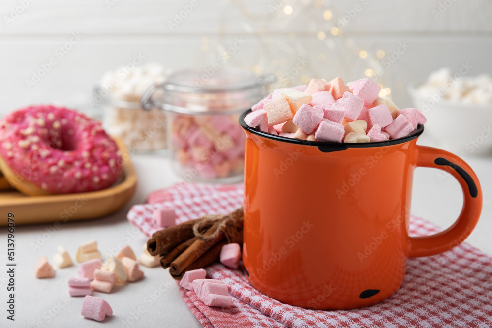Cocoa drink on texture background. Hot chocolate with small marshmallows and spices. Winter warming drink concept. Space for copy. Space for text Cocoa drink on texture background. Hot chocolate with small marshmallows and spices. Winter warming drink concept. Space for copy. Space for text