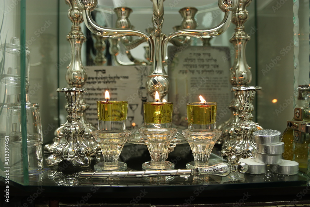 Shabbat candles are lit with oil in silver candlesticks. Orthodox ...