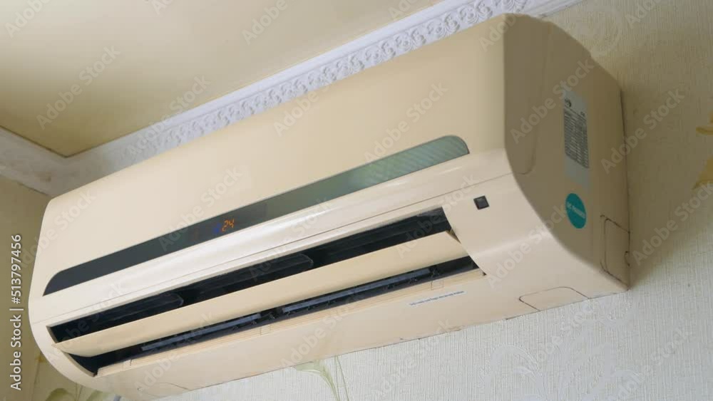 The air conditioner hangs on the wall and cools the air in the room, split system. The air conditioner hangs on the wall and cools the air in the room, split system.