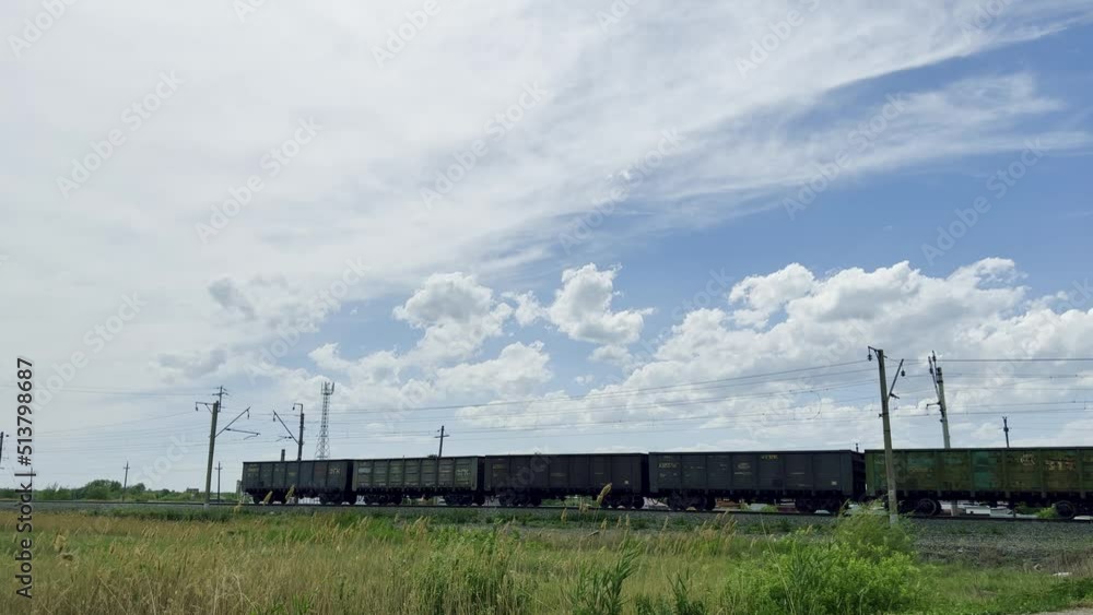 A moving freight train from a large number of containers delivers cargo. High quality 4k footage A moving freight train from a large number of containers delivers cargo. High quality 4k footage