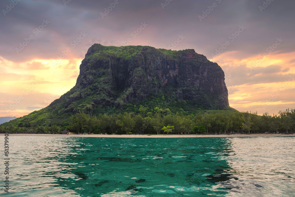 View of the mountain in Le Morne Brabant and the bay with boats on the island of Mauritius in the Indian Ocean.