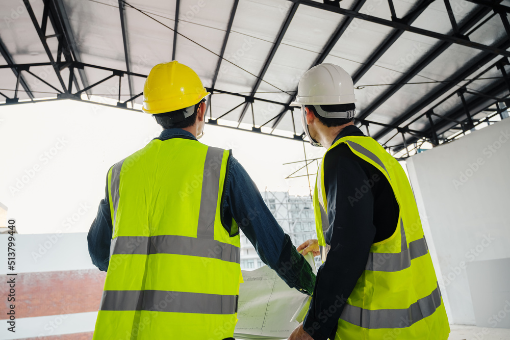 Civil Engineer and Construction Supervisor inspect the internal construction of building at construction site. Construction engineers or architect and Foreman inspect the construction inside building. Civil Engineer and Construction Supervisor inspect the internal construction of building at construction site. Construction engineers or architect and Foreman inspect the construction inside building.