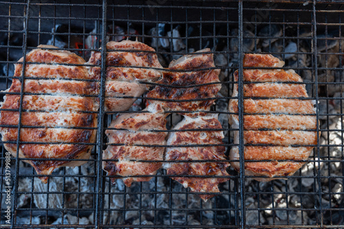 Grilling pork meat on the s...