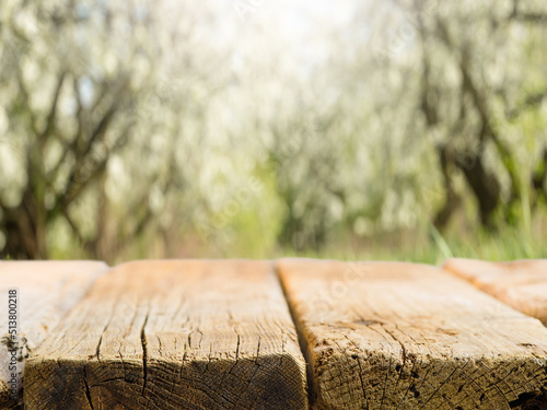 Wooden table on the background of picturesque nature. Minimalism. Defocused background. Camping, picnic, healthy lifestyle. There are no people in the photo.