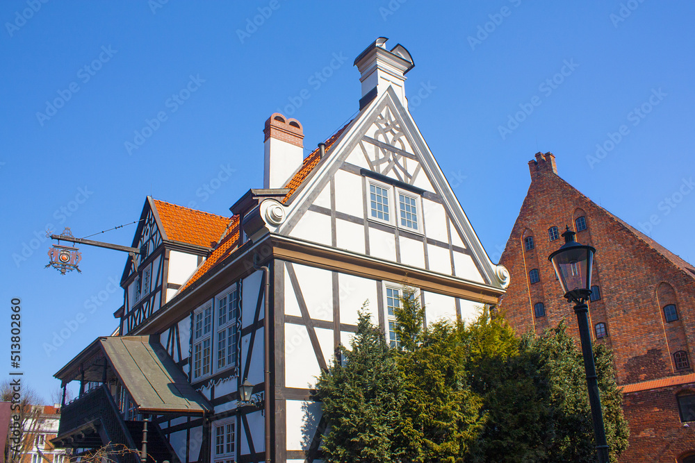 Picturesque scenery of half-timbered building on the river island near Great Mill (Dwor Mlynarzy) in Old Town of Gdansk, Poland	
