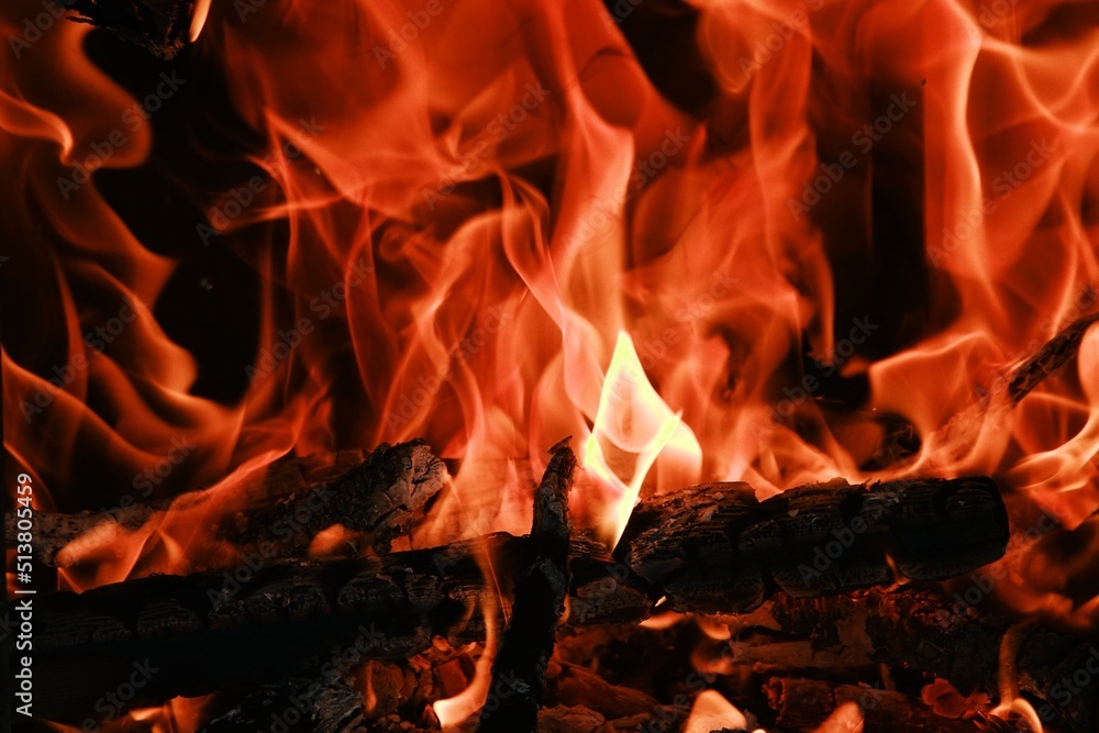 Fire flames from a wood stove fire isolated on a black background Fire flames from a wood stove fire isolated on a black background