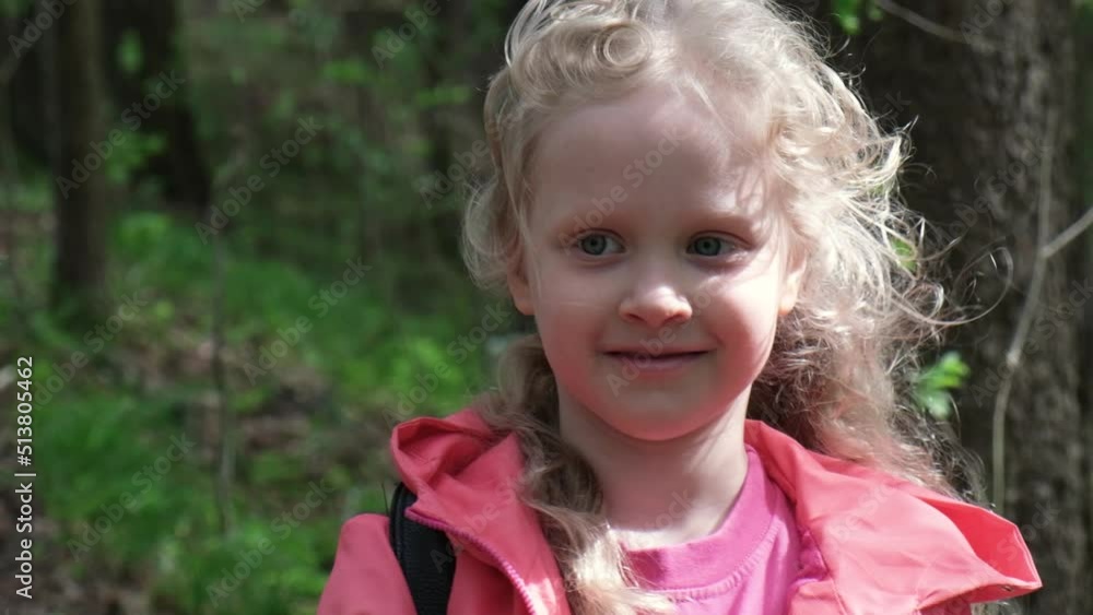 Happy blond girl iwith curly hair n rays of the sun. Girl in park or forest close-up. Happy blond girl iwith curly hair n rays of the sun. Girl in park or forest close-up.