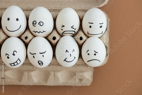 concept social networks communication and emotions - eggs on beige background