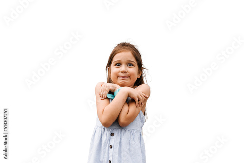 Scared child girl on a white background. Toddler stress and fears. Negative kid emotions.