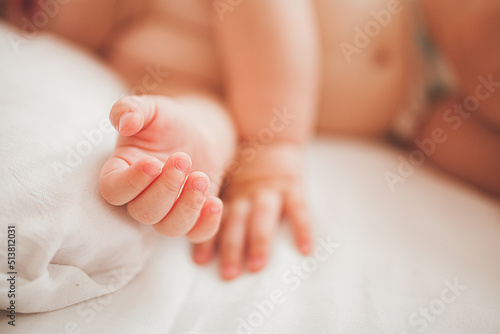 Cute little baby sleeping. Tiny infant`s hands in front.