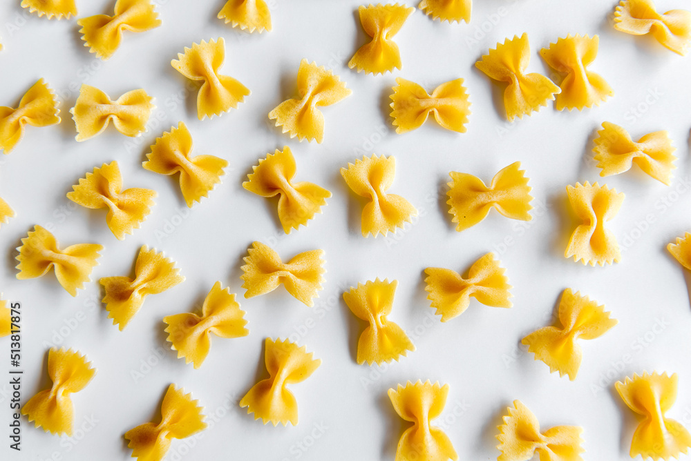 raw tie pasta on white background (farfalle italian pasta). raw tie pasta on white background (farfalle italian pasta).