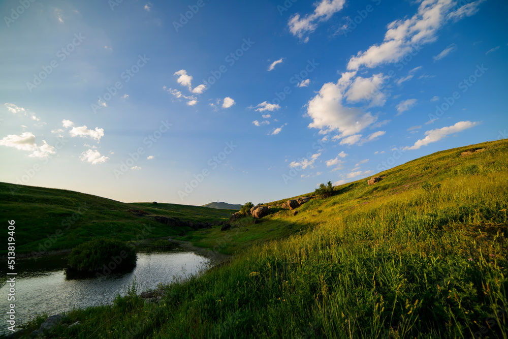 Obraz premium Beautiful panoramic landscape sunset over the river and hills.
