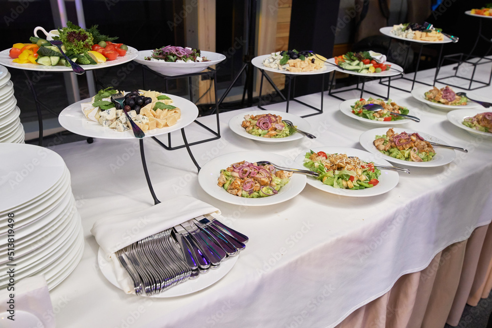 buffet with appetizers, salads in plates at the banquet