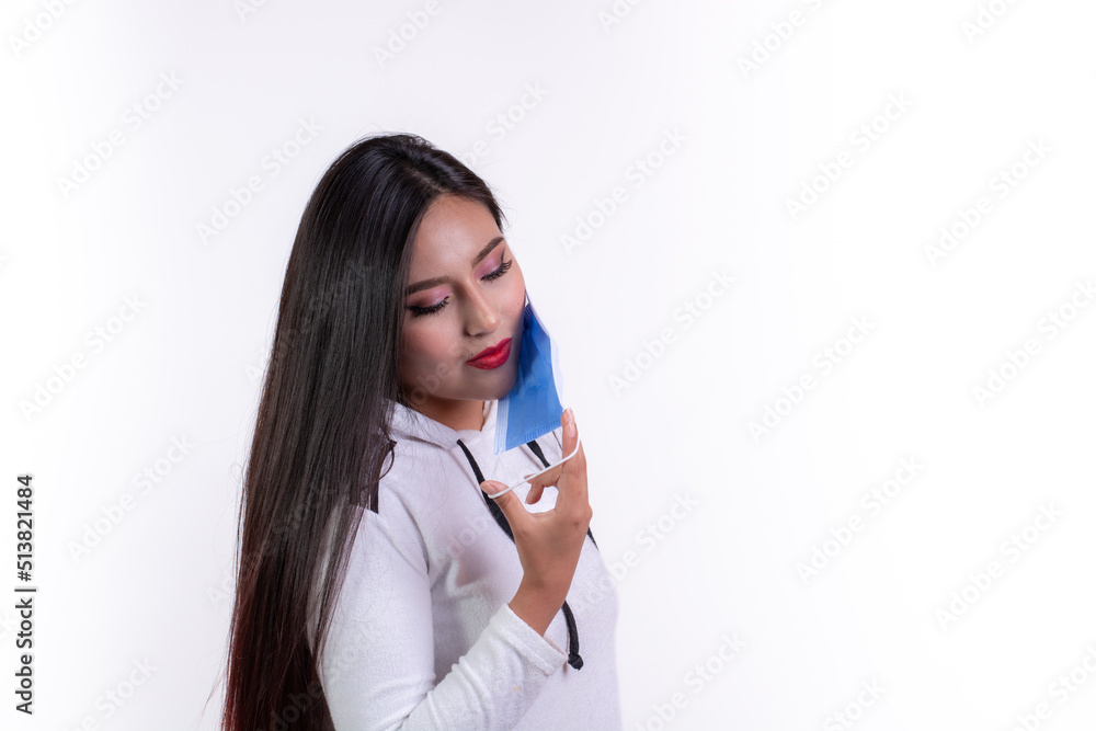 hispanic girl holding a ready-to-use surgical mask, personal care concept against infection hispanic girl holding a ready-to-use surgical mask, personal care concept against infection