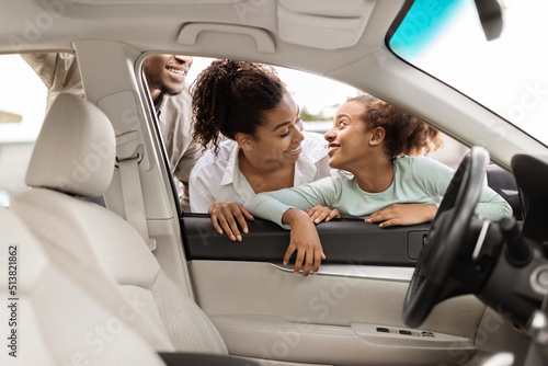 Cheerful African Family Choosing Car Looking At Automobile Interior Outdoor