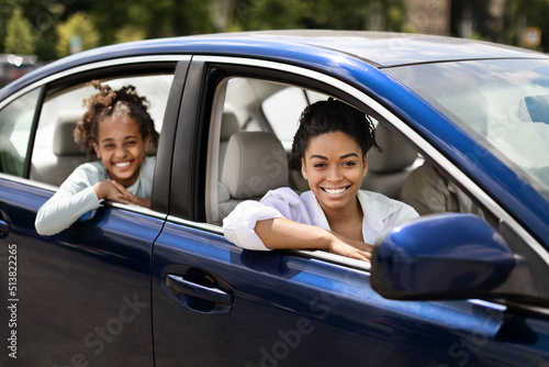 Cheerful Black Mother And Daughter Sitting In New Auto © Prostock-studio