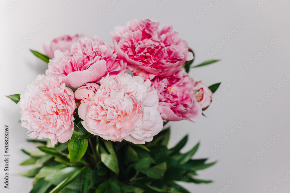 Beautiful bouquet of pink pastel peony flowers on a white background.